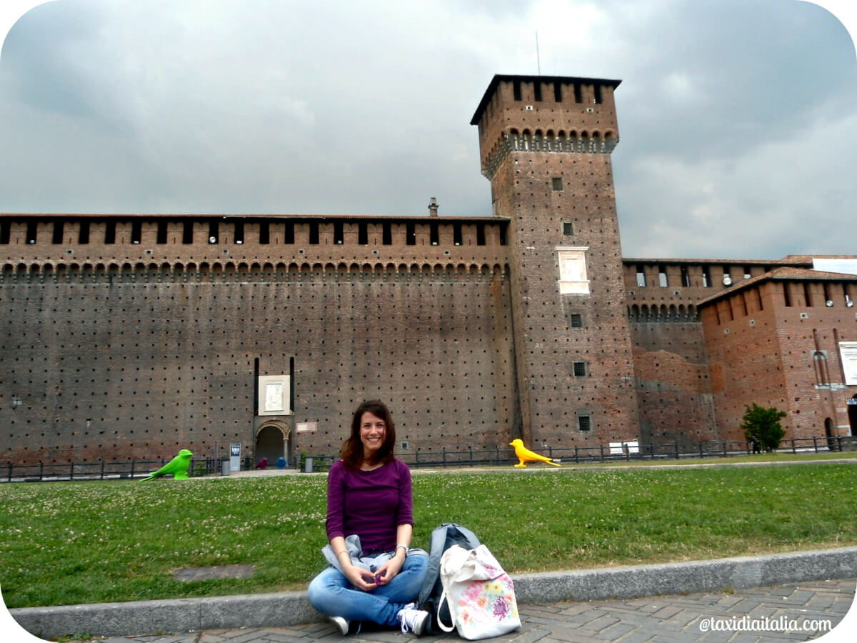 girl sitting in front of castello sforzesco, Milan 